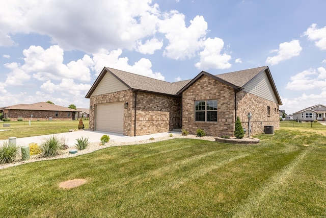 view of front of house with a front yard, a garage, and central air condition unit