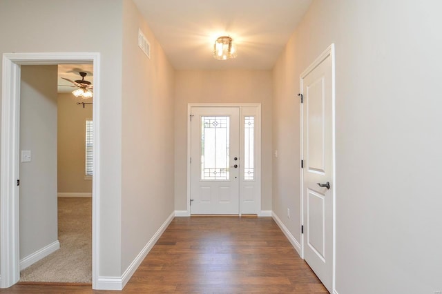 entrance foyer with visible vents, baseboards, and wood finished floors