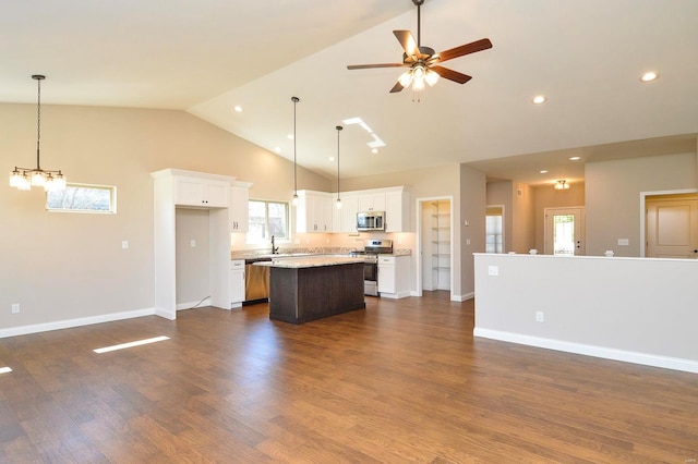 kitchen with open floor plan, dark wood finished floors, a center island, white cabinetry, and appliances with stainless steel finishes