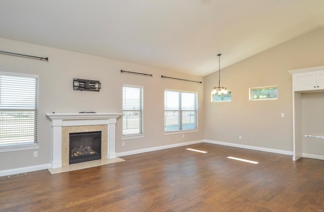 unfurnished living room featuring dark wood finished floors, visible vents, a fireplace, and lofted ceiling