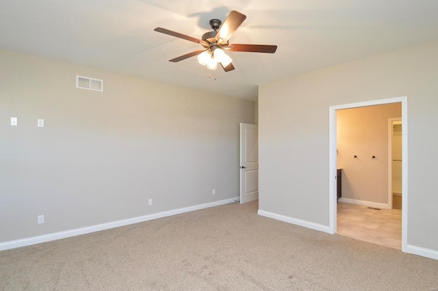 unfurnished bedroom featuring ceiling fan, baseboards, visible vents, and light carpet