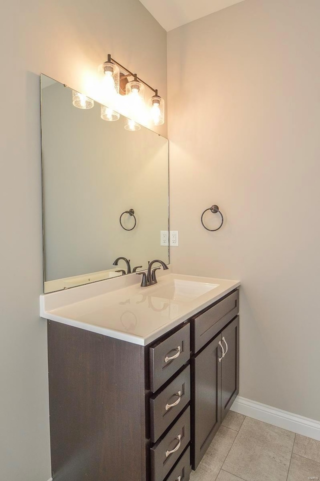 bathroom with tile patterned floors, baseboards, and vanity