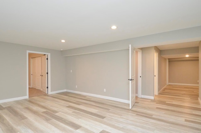 unfurnished room with recessed lighting, baseboards, and light wood finished floors