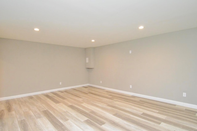 spare room with recessed lighting, baseboards, and light wood-style flooring