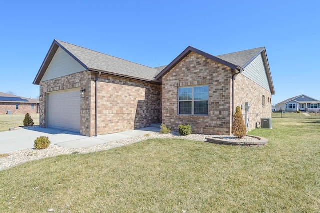 ranch-style house with brick siding, central air condition unit, concrete driveway, a front yard, and an attached garage