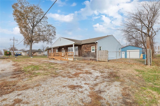 view of front of home with covered porch and an outbuilding