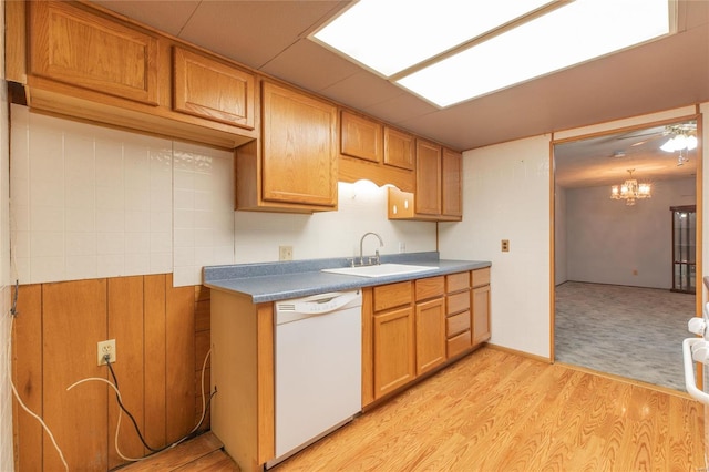 kitchen with dishwasher, light hardwood / wood-style flooring, ceiling fan with notable chandelier, and sink