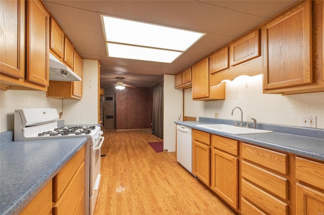 kitchen with tasteful backsplash, white appliances, ceiling fan, sink, and light hardwood / wood-style floors