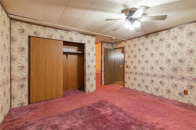 unfurnished bedroom with carpet flooring, ceiling fan, and a textured ceiling