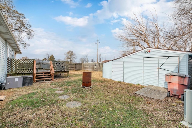 view of yard featuring central AC and a storage shed