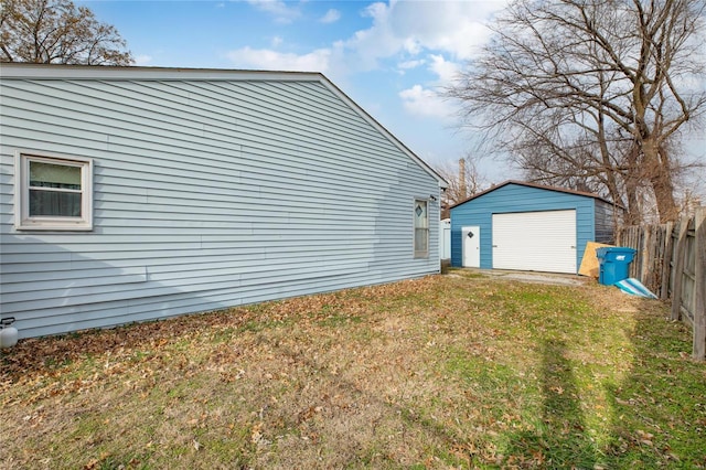 view of property exterior featuring a yard, an outbuilding, and a garage