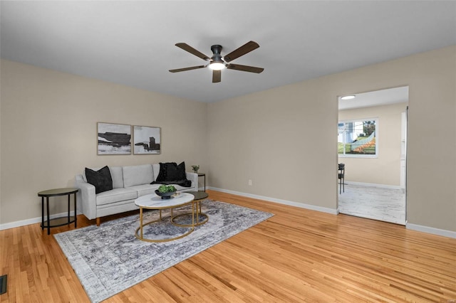 living room featuring ceiling fan and light wood-type flooring