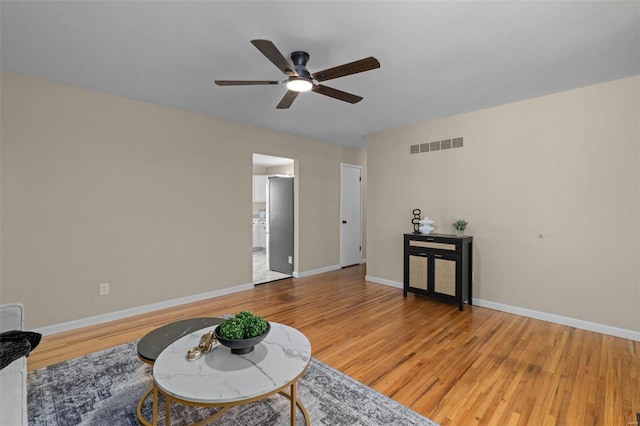 sitting room featuring hardwood / wood-style floors and ceiling fan