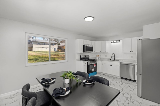 kitchen featuring white cabinetry, sink, and stainless steel appliances