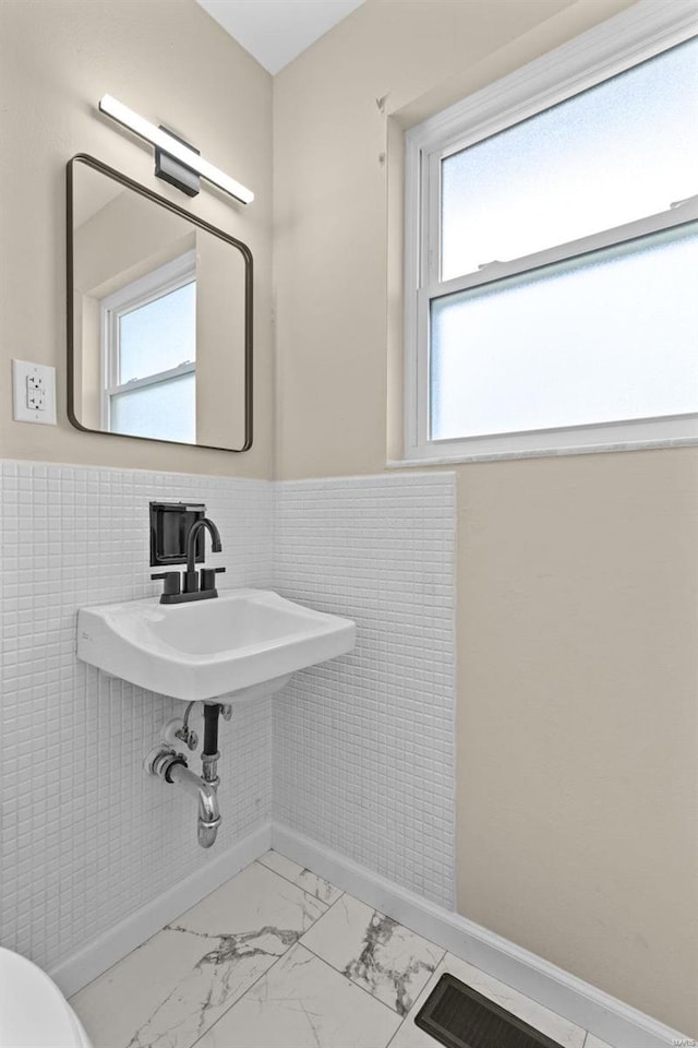 bathroom with tile walls