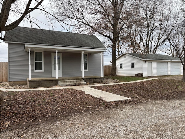 view of front of property with an outbuilding, a porch, and a garage