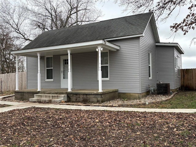 bungalow-style home with central AC unit and covered porch