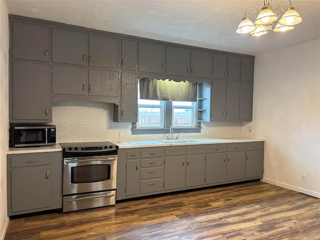 kitchen with sink, gray cabinetry, backsplash, hanging light fixtures, and stainless steel electric range oven