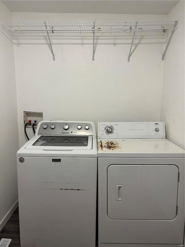 laundry area featuring separate washer and dryer and dark wood-type flooring