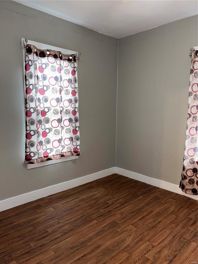 empty room featuring dark wood-type flooring