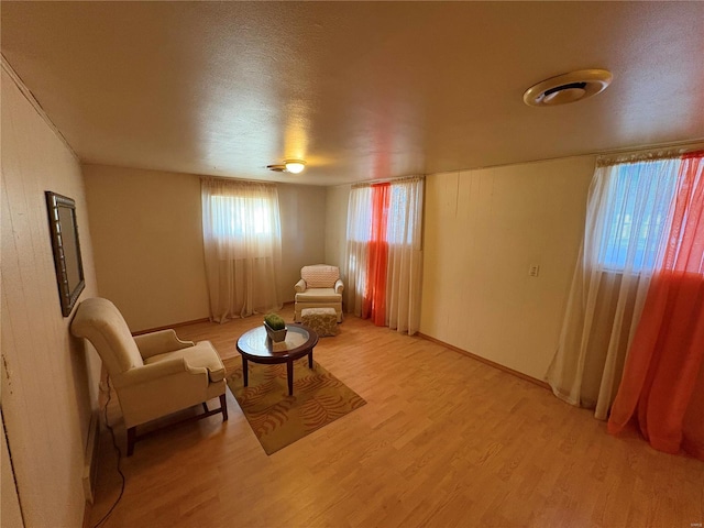 sitting room with a textured ceiling and light wood-type flooring