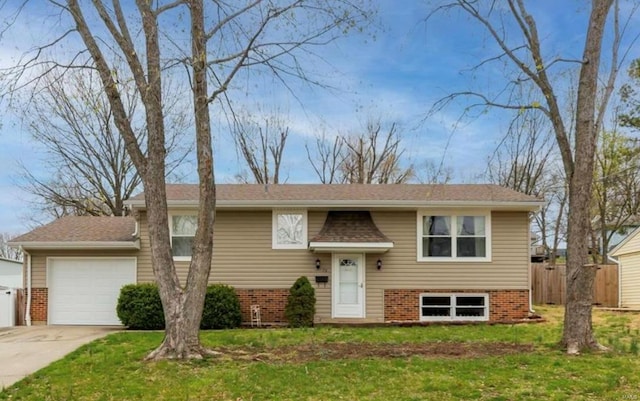 raised ranch with a garage and a front yard