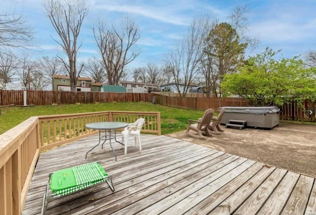 deck featuring a yard and a hot tub