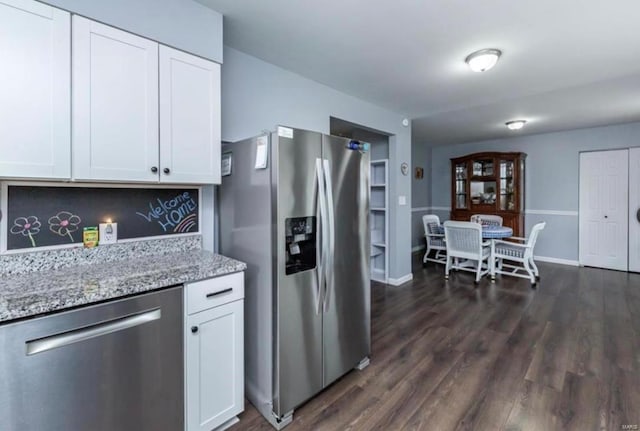 kitchen featuring light stone countertops, stainless steel appliances, dark hardwood / wood-style floors, decorative backsplash, and white cabinets