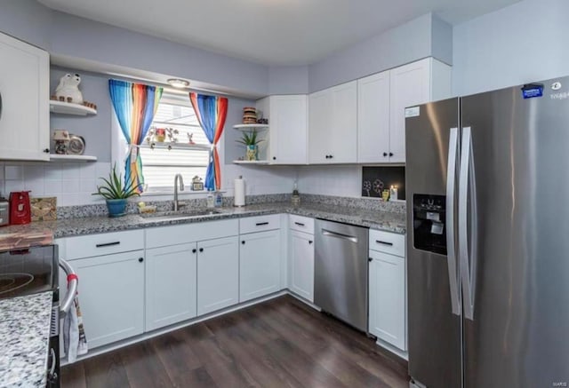 kitchen with white cabinetry, sink, stainless steel appliances, and light stone counters