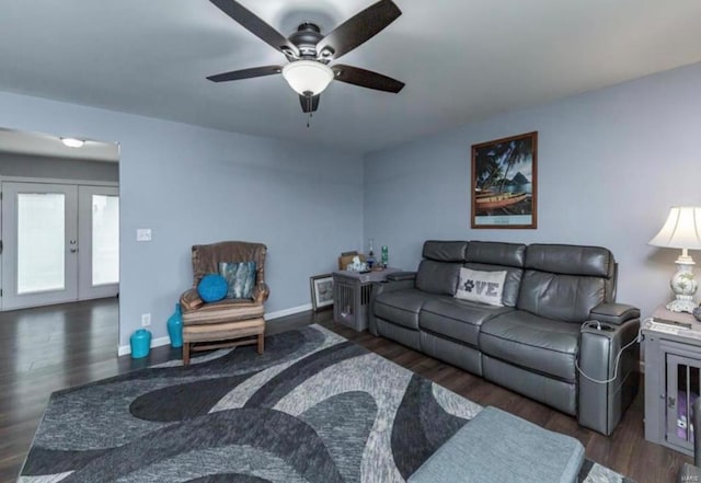 living room with french doors, ceiling fan, and dark wood-type flooring