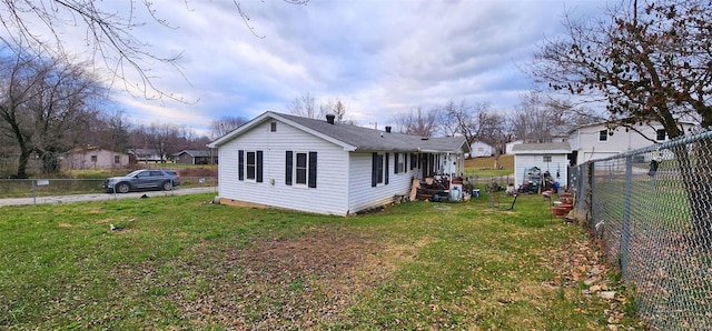 back of house with a lawn