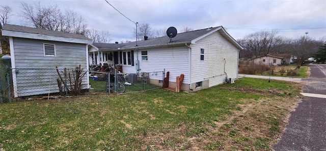 rear view of property with a lawn