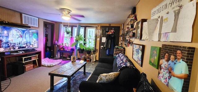 carpeted living room featuring ceiling fan