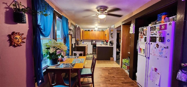 kitchen with white fridge, ceiling fan, and light hardwood / wood-style floors