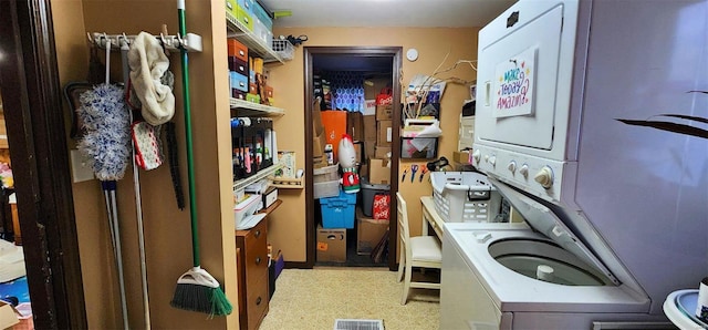 laundry room with stacked washer / dryer