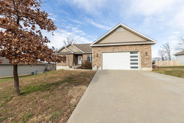 view of front of house featuring a front yard and a garage