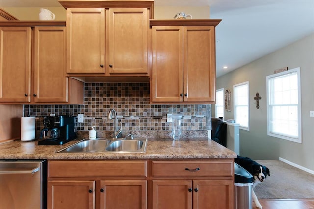 kitchen featuring dishwasher, hardwood / wood-style floors, tasteful backsplash, and sink