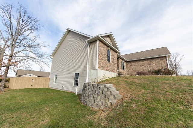 view of property exterior with a lawn