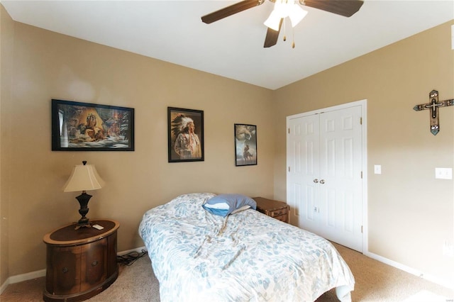 carpeted bedroom with ceiling fan and a closet