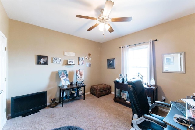 home office featuring light carpet and ceiling fan