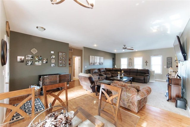 living room with ceiling fan and light hardwood / wood-style floors