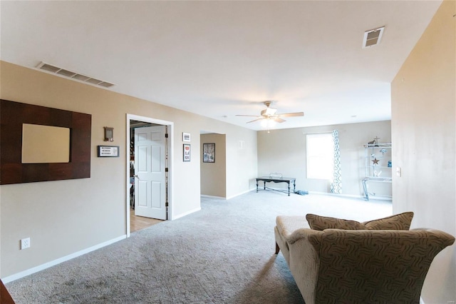 carpeted living room with ceiling fan