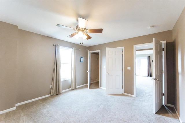 unfurnished bedroom featuring ceiling fan and light colored carpet