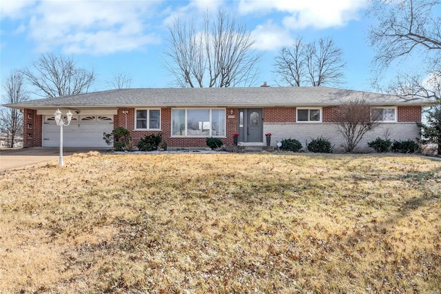 single story home with a garage and a front lawn