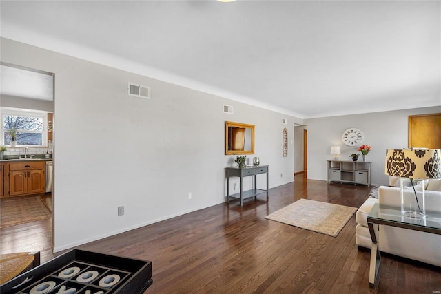 living room featuring dark hardwood / wood-style flooring and sink