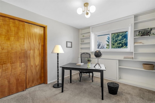 carpeted office with a chandelier