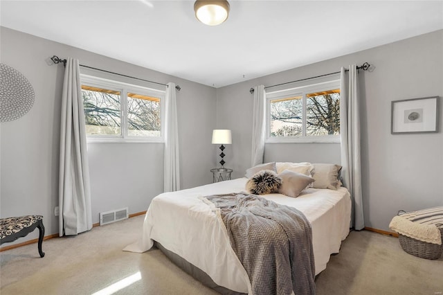 bedroom featuring multiple windows and carpet floors