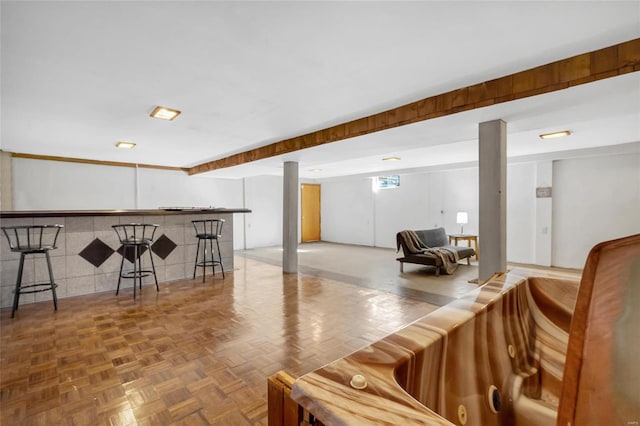 interior space featuring parquet flooring and bar area