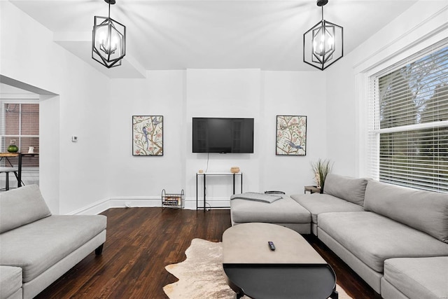 living room featuring wood-type flooring and a notable chandelier