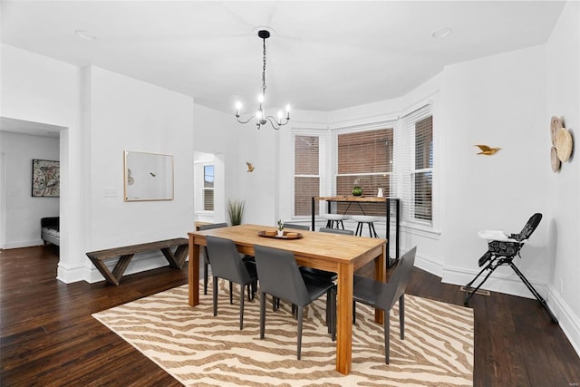 dining area featuring an inviting chandelier and hardwood / wood-style floors